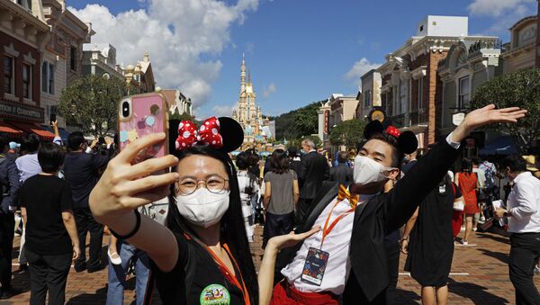 Visitantes tiram selfie no dia da reabertura do parque temático da Disneylândia, em Hong Kong, 18 de julho de 2020   - Sputnik Brasil