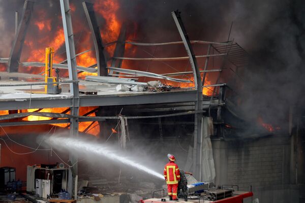 Bombeiro luta contra as chamas que se espalharam por um depósito do porto de Beirute, capital do Líbano - Sputnik Brasil