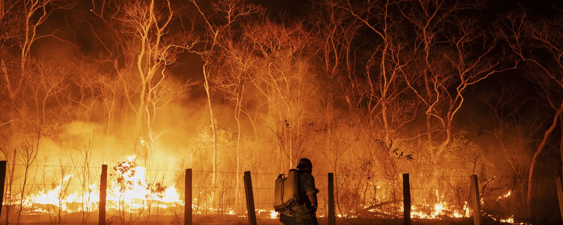 Funcionários monitoram um acero na tentativa de controlar um foco de incêndio na fazenda Santa Tereza, na região da Serra do Amolar, no Pantanal do Mato Grosso do Sul. Cerca de 60% da fazenda foi consumida pelo fogo, outubro de 2020 - Sputnik Brasil, 1920, 28.12.2020
