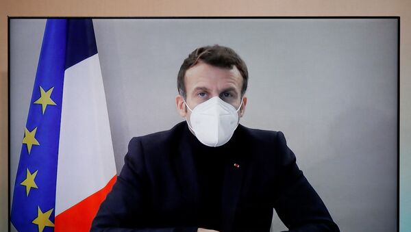 O presidente da França, Emmanuel Macron, com teste positivo para COVID-19, é visto em uma tela enquanto participa por videoconferência de uma mesa redonda da Conferência Humanitária Nacional (NHC) - Sputnik Brasil