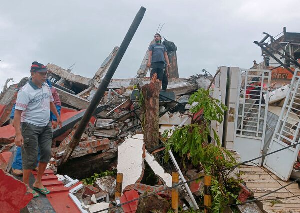 Moradores verificam casas danificadas pelo terremoto em Mamuju, Sulawesi Ocidental, Indonésia, 15 de janeiro de 2021 - Sputnik Brasil