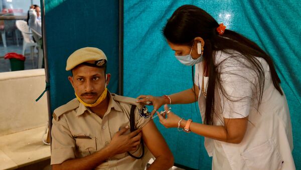 Policial indiano recebendo dose da vacina COVISHIELD, fabricada pelo Instituto Serum da Índia - Sputnik Brasil