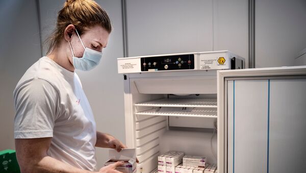 Membro da equipe lida com vacinas da AstraZeneca contra a COVID-19 armazenadas no Centro de Vacinas da Região Hovedstaden, Copenhague, Dinamarca, 11 de fevereiro de 2021 - Sputnik Brasil
