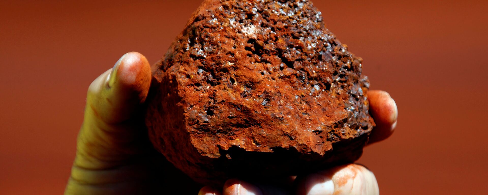 Um minerador detém um pedaço de minério de ferro em uma mina localizada na região de Pilbara, no oeste da Austrália, 21 de março de 2021 - Sputnik Brasil, 1920, 06.04.2021