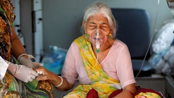 Indiana usando máscara de oxigênio dentro de ambulância enquanto espera ser internada em hospital da COVID-19 em Ahmedabad, Índia, 5 de maio de 2021 - Sputnik Brasil