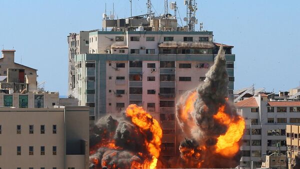 O prédio Al-Jalaa que abrigava os escritórios de mídia da Associated Press (AP) e da Al Jazeera é atingido por um ataque aéreo israelense na cidade de Gaza, em 15 de maio de 2021 - Sputnik Brasil