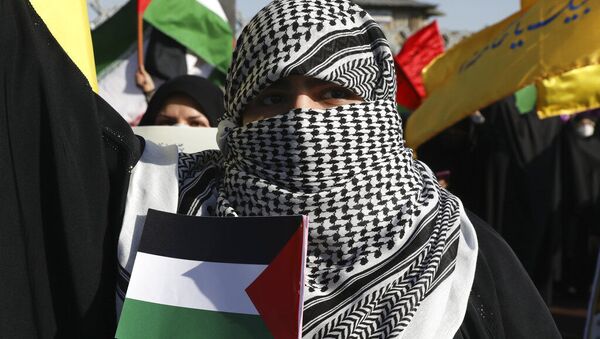 Manifestante cobre o rosto no estilo de militantes palestinos enquanto segura uma bandeira da Palestina em uma reunião pró-palestinos em Teerã, Irã - Sputnik Brasil