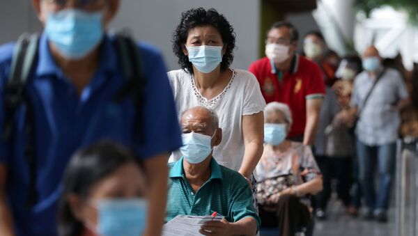 Pessoas esperam na fila para receber a vacina contra a COVID-19 em Kuala Lumpur, Malásia, 31 de maio de 2021 - Sputnik Brasil