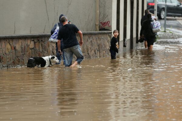 Pessoas caminham por rua inundada após chuvas torrenciais em Hagen, Alemanha
 - Sputnik Brasil