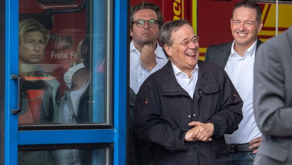 CDU leader and North Rhine-Westphalia's State Premier Armin Laschet laughs as the German president (unseen) delivers a speech during their visit to flood-hit Erftstadt, Germany July 17, 2021. - Sputnik Brasil