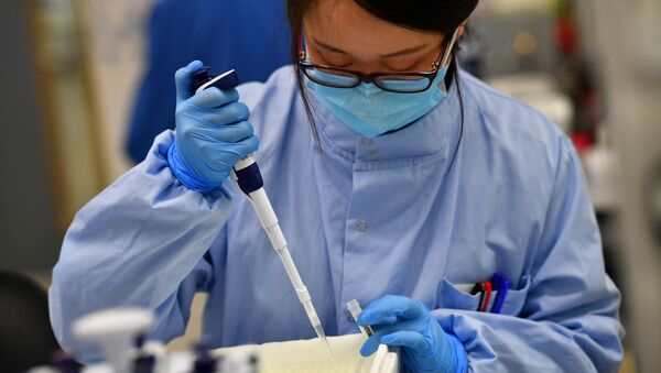 Cientistas trabalham em um laboratório onde sequenciam os novos genomas de coronavírus em Cambridge, Reino Unido, 12 de março de 2021 - Sputnik Brasil