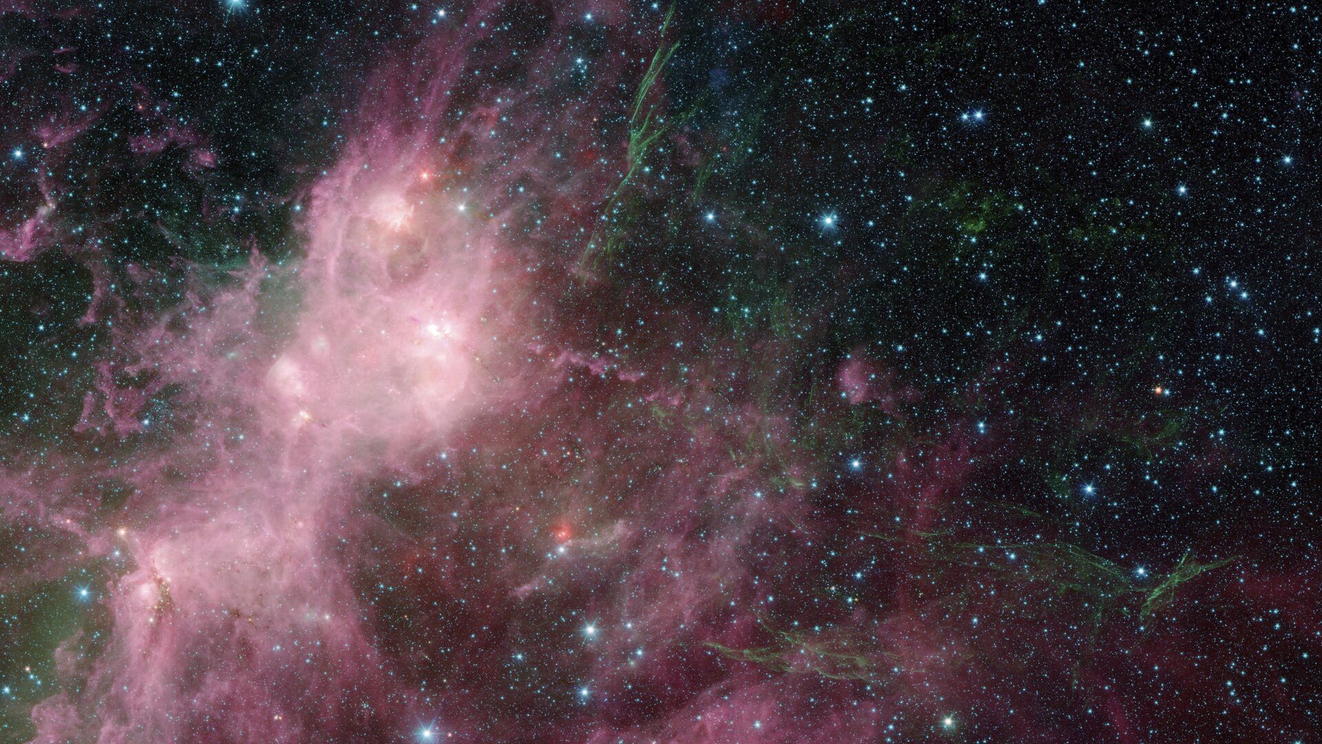 Imagem fornecida pela NASA de dados infravermelhos obtidos pelo telescópio espacial Spitzer e pelo telescópio Wide Field Infrared Explorer (WISE) em uma área onde estrelas conhecidas como W3 e W5 se formam na Via Láctea - Sputnik Brasil, 1920, 08.08.2021