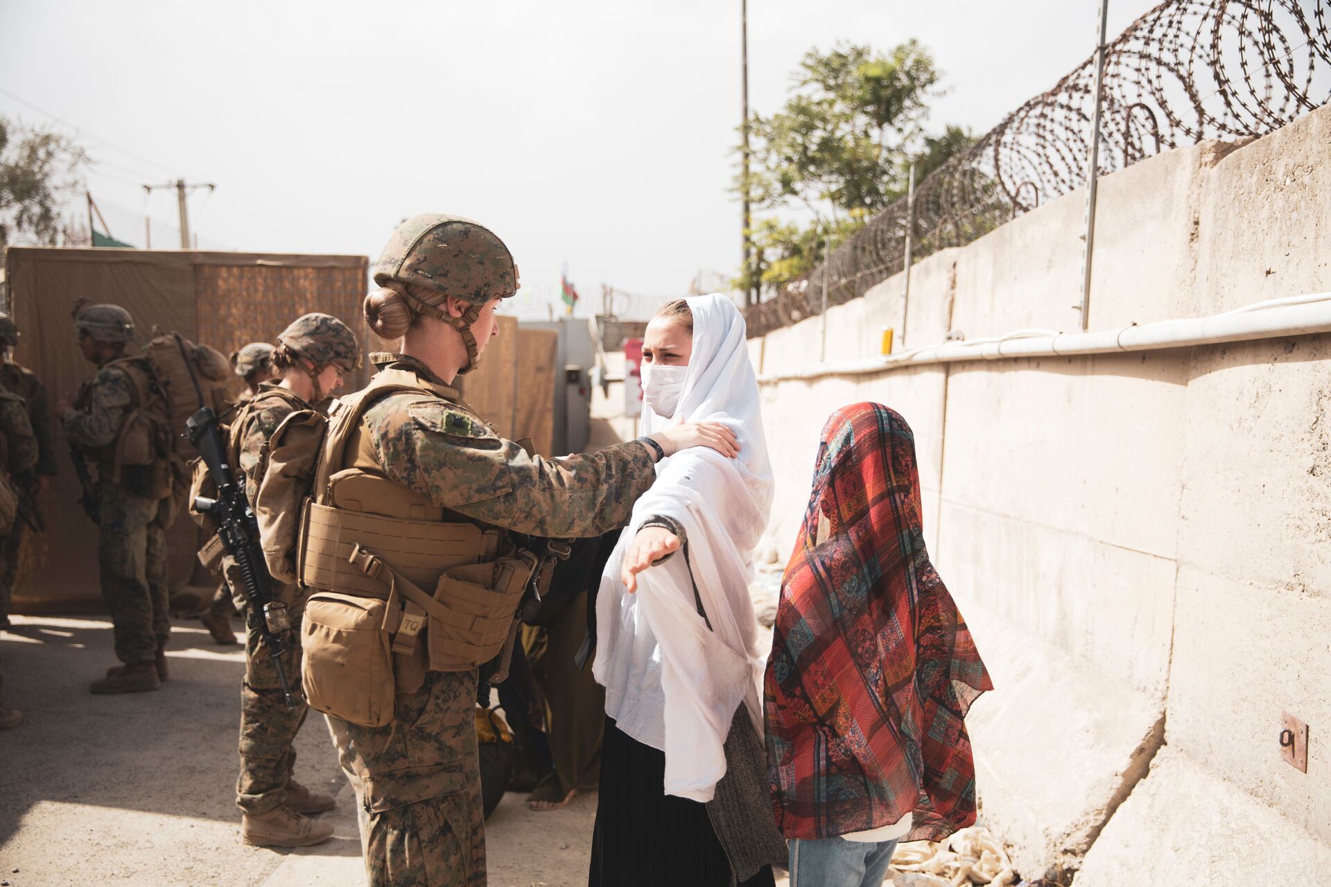 Fuzileira naval dos EUA verifica dois civis durante processo de evacuação no Aeroporto Internacional Hamid Karzai, Cabul, Afeganistão, 18 de agosto de 2021 - Sputnik Brasil, 1920, 09.11.2021