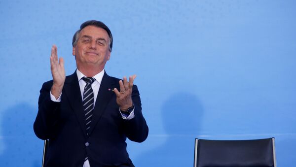 O Presidente Jair Bolsonaro reage durante a cerimônia do Dia Nacional do Voluntariado no Palácio do Planalto em Brasília, Brasil, 26 de agosto de 2021 - Sputnik Brasil