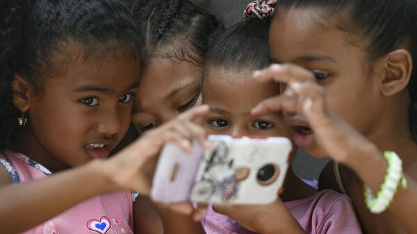 Crianças com celular em Caracas, Venezuela - Sputnik Brasil