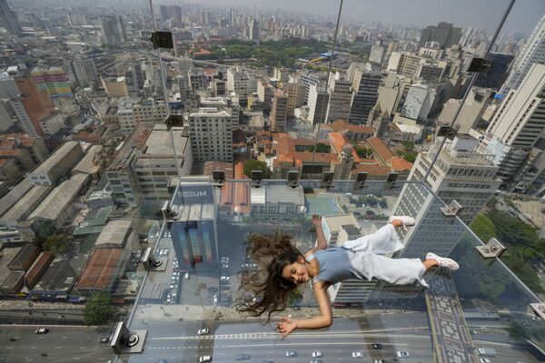 Garota deitada no mirante Sampa Sky totalmente em vidro no 42º andar do edifício Mirante do Vale no centro de São Paulo, Brasil, 29 de setembro de 2021. - Sputnik Brasil