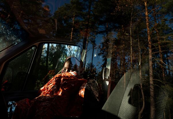 Imigrante da Somália sentada em uma ambulância na fronteira entre Belarus e Polônia em Siemianowka, Polônia. - Sputnik Brasil
