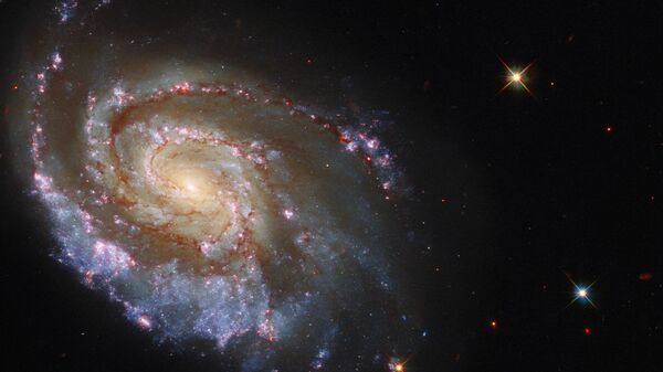 Telescópio Espacial Hubble mostra a imagem da galáxia espiral NGC 6984, na constelação Indus, a aproximadamente 200 milhões de anos-luz da Terra - Sputnik Brasil