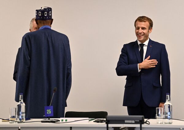 Príncipe britânico Charles fala com o presidente da Nigéria, Muhammadu Buhari, ao lado do presidente da França, Emmanuel Macron, à margem da conferência COP26 em Glasgow, Escócia, Reino Unido, 1º de novembro de 2021.    - Sputnik Brasil