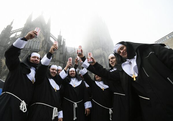 Homens vestidos de freiras bebem cerveja celebrando o Carnaval, que na Alemanha se festeja em novembro, perto da catedral de Colônia, na Alemanha, em 11 de novembro de 2021. - Sputnik Brasil
