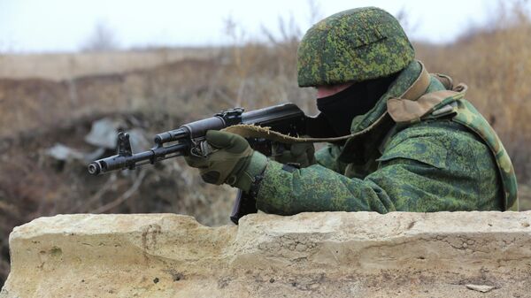 Um militar segura sua arma Kalashnikov, próximo a Sentianivka, região de Luhansk, controlada por separatistas apoiados pela Rússia, no leste da Ucrânia, no dia 9 de dezembro de 2021 - Sputnik Brasil