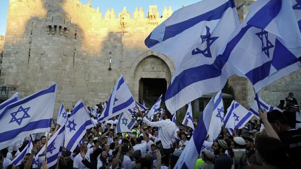 Judeus agitam bandeiras israelenses durante a Marcha das Bandeiras, próximo ao portão de Damasco, fora da Cidade Velha de Jerusalém, 15 de junho de 2021.  - Sputnik Brasil