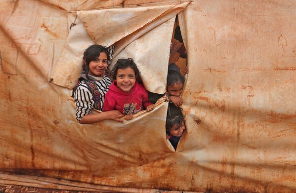 Crianças assistem a aulas em um acampamento para refugiados na vila síria de Killi, junto da fronteira com a Turquia, 20 de dezembro de 2021. - Sputnik Brasil