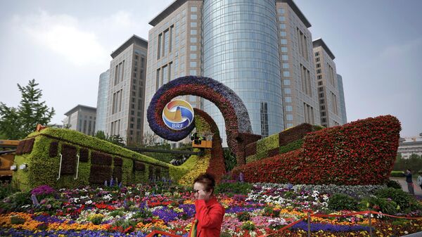 Mulher passa ao lado de plataforma promovendo Fórum de Um Cinturão, Uma Rota em Pequim, China, 23 de abril de 2019 - Sputnik Brasil