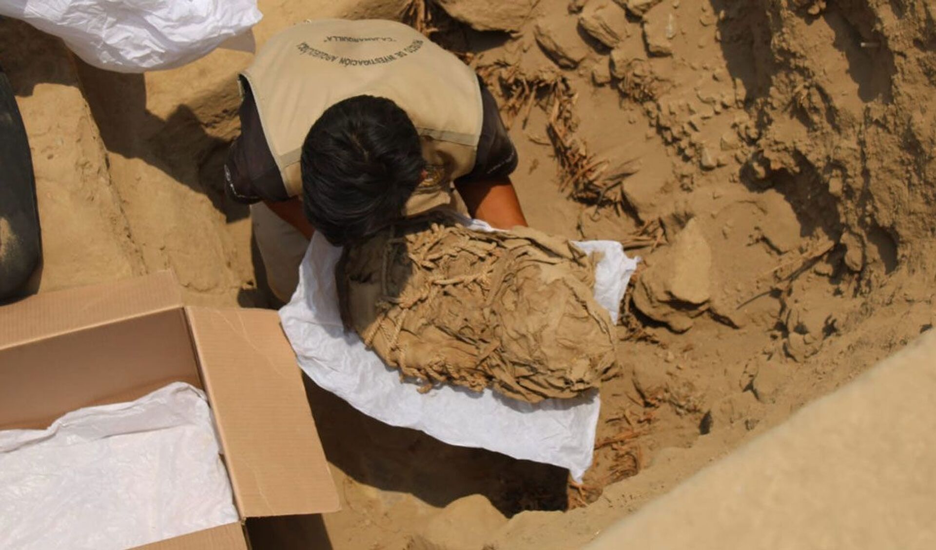 Momento em que é extraído um dos fardos que contém restos de uma criança, complexo arqueológico de Cajamarquilla, Lima - Sputnik Brasil, 1920, 15.02.2022