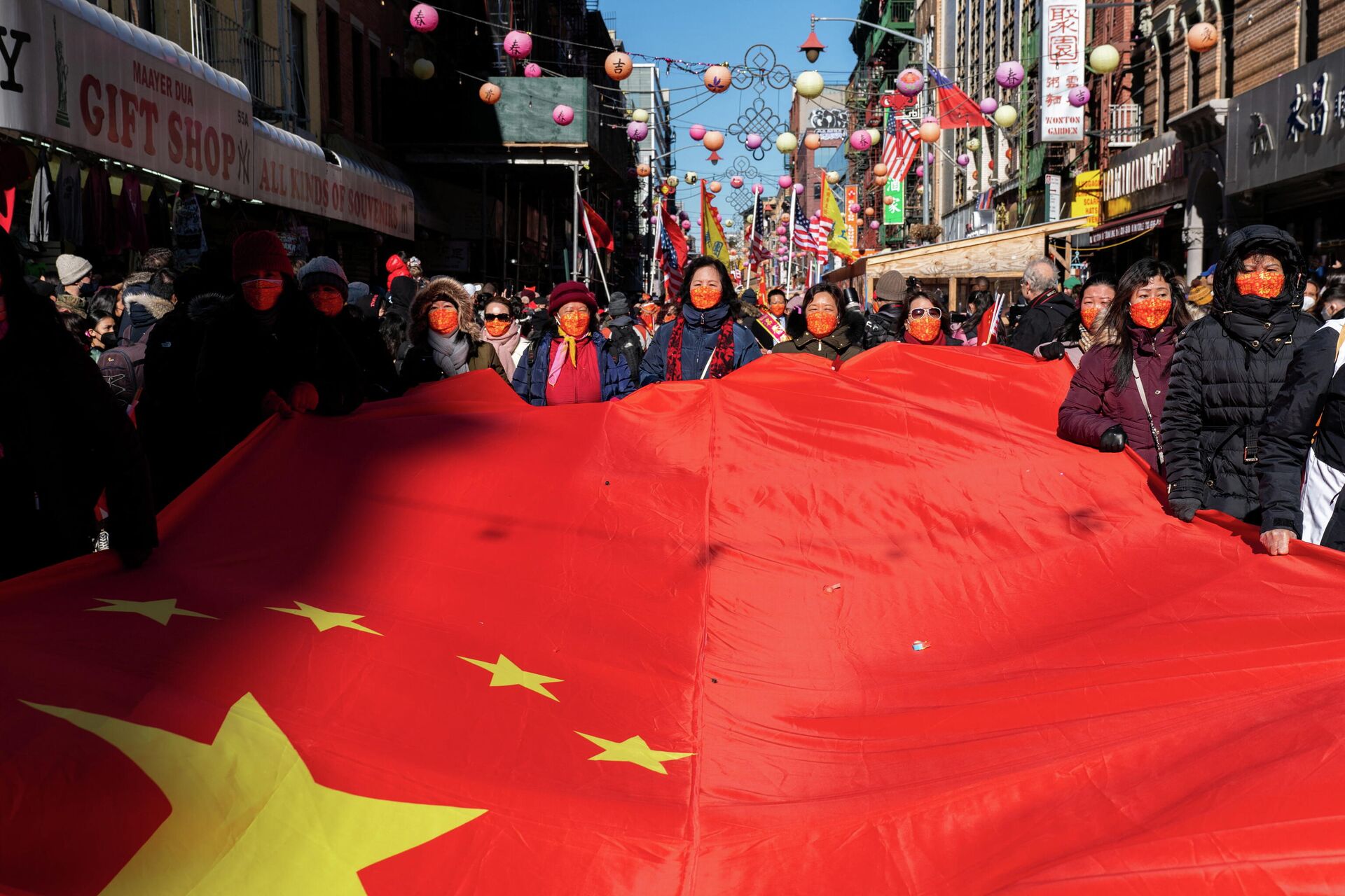 Pessoas seguram uma bandeira nacional chinesa enquanto celebram durante o desfile do Ano Novo Lunar em Chinatown em Nova York, EUA, em 20 de fevereiro de 2022 - Sputnik Brasil, 1920, 23.02.2022
