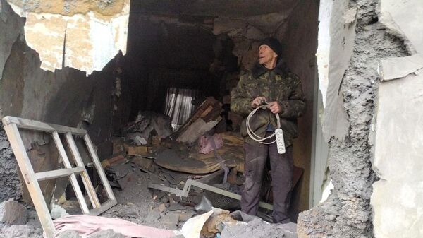 Morador de Gorlovka, na República Popular de Donetsk (RPD), em casa destruída por bombardeios de lançadores múltiplos de foguetes BM-21 Grad - Sputnik Brasil