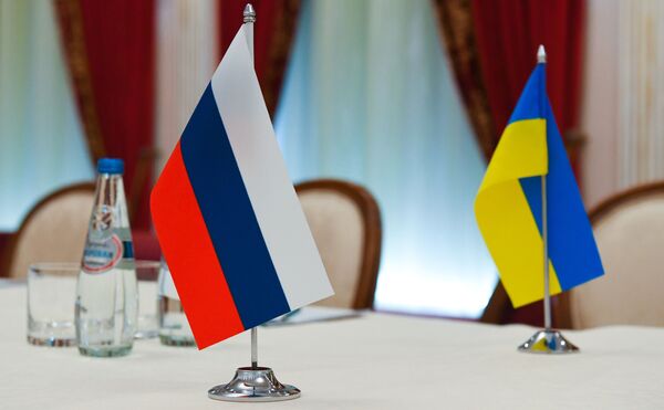Bandeiras da Rússia e da Ucrânia na sala onde decorrem as negociações Rússia-Ucrânia em Belarus, 28 de fevereiro de 2022. - Sputnik Brasil