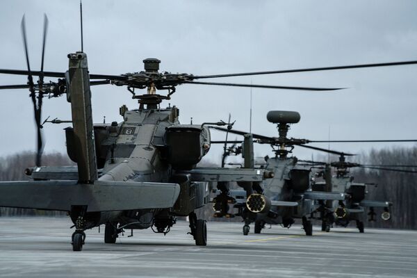Quase 20 helicópteros AH-64D Apache Longbow, atribuídos ao 1º, 2º e 3º Batalhões de Ataque, 12ª Brigada de Aviação de Combate dos EUA, chegam ao Aeródromo Militar de Lielvarde em Ogre, Letônia, 24 de fevereiro de 2022 - Sputnik Brasil