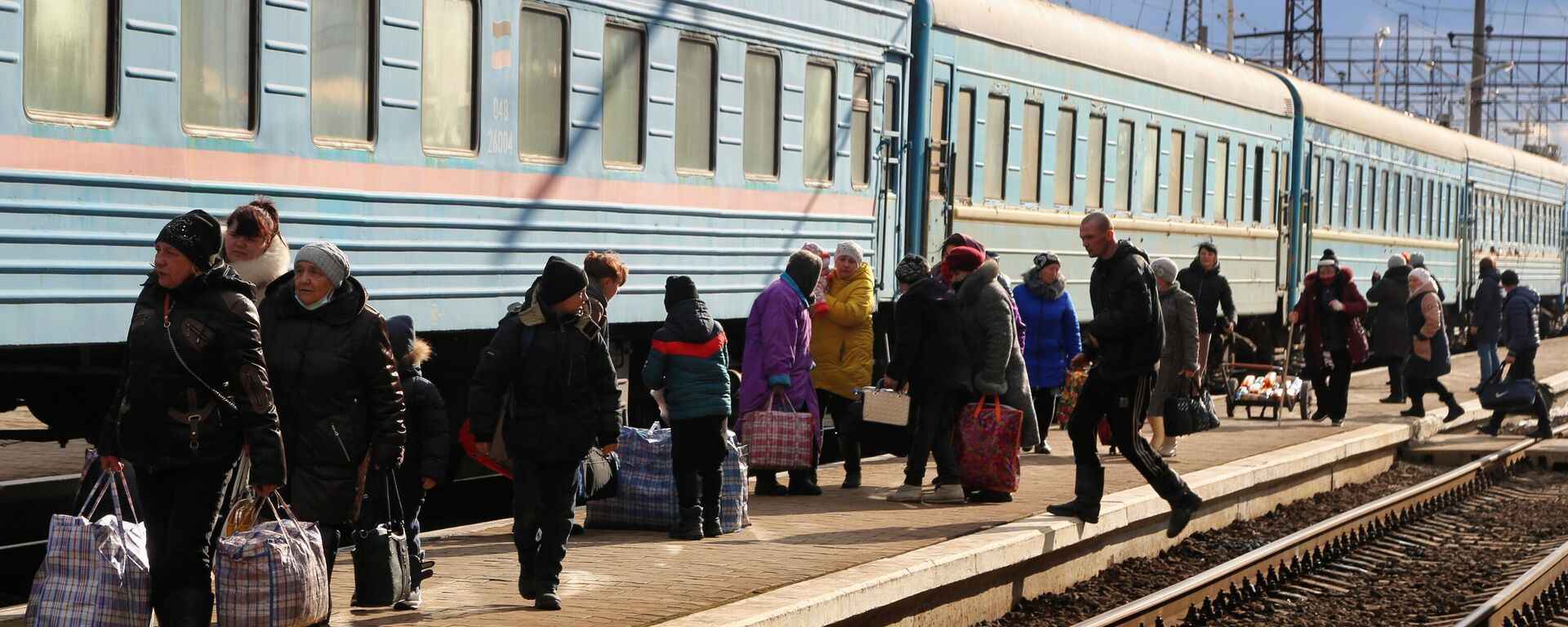 Em Rostov, na Rússia, moradores da República Popular de Donetsk (RPD) caminham na estação ferroviária de Debaltsevo durante a evacuação para o território russo, em 19 de fevereiro de 2022 - Sputnik Brasil, 1920, 25.06.2022