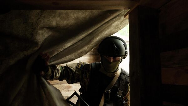 Um soldado da Guarda Nacional Ucraniana entra em um abrigo subterrâneo em uma posição perto de Kharkiv, Ucrânia, segunda-feira, 9 de maio de 2022 - Sputnik Brasil