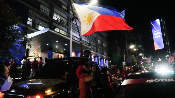 Manifestante carrega bandeira das Filipinas em 9 de maio de 2022 - Sputnik Brasil