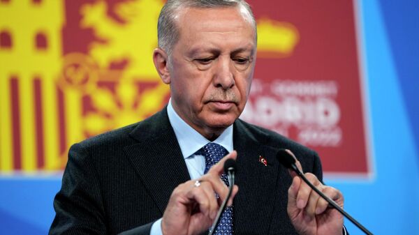 O presidente turco Recep Tayyip Erdogan testa o microfone antes de discursar em uma coletiva de imprensa em uma cúpula da OTAN em Madri, Espanha, na quinta-feira, 30 de junho de 2022 - Sputnik Brasil