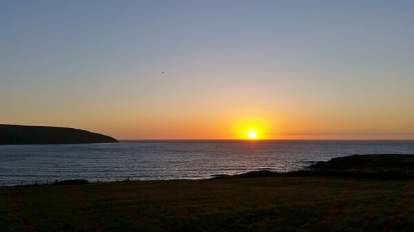Pôr-do-sol sobre a baía de Cardigan, Gwbert, País de Gales, Reino Unido - Sputnik Brasil