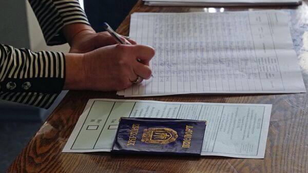 Mulher se registra no local de votação em Kherson no referendo sobre a adesão da região de Kherson à Rússia, em 23 de setembro de 2022 - Sputnik Brasil