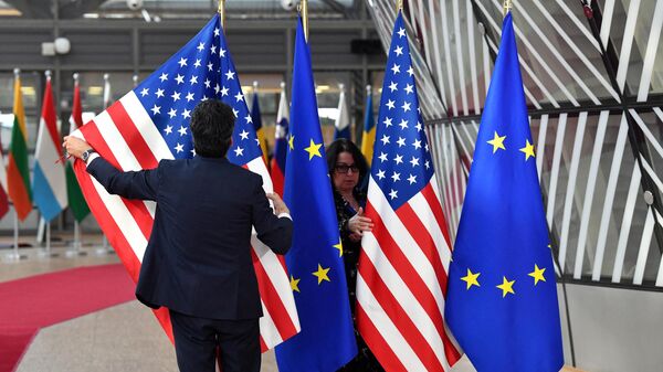 Bandeiras dos EUA e da União Europeia são preparadas para a chegada de Joe Biden, presidente dos EUA, à cúpula da União Europeia na sede do bloco, em Bruxelas, na Bélgica, em 24 de março de 2022 - Sputnik Brasil