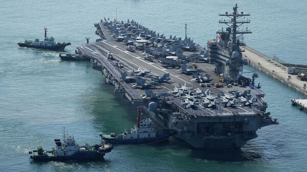 O porta-aviões norte-americano USS Ronald Reagan é escoltado ao chegar a Busan, Coreia do Sul, em 23 de setembro de 2022. A Coreia do Norte lançou dois mísseis balísticos de curto alcance em direção às águas do leste, 6 de outubro de 2022 - Sputnik Brasil