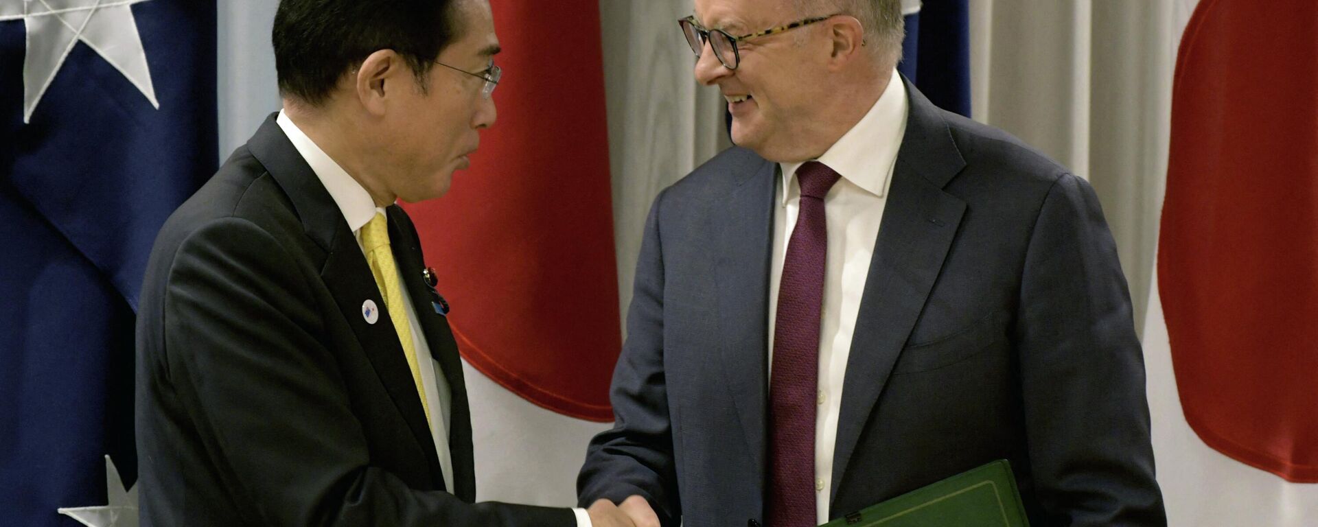 Fumio Kishida e Anthony Albanese, primeiros-ministros do Japão e da Austrália, respetivamente, apertam as mãos durante cerimônia de assinatura de acordos bilaterais e uma declaração conjunta em Perth, Austrália, 22 de outubro de 2022 - Sputnik Brasil, 1920, 22.10.2022