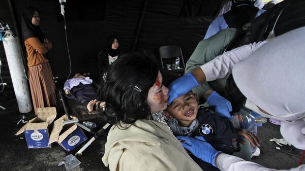 Sobreviventes do terremoto que atingiu a província de Java Ocidental, na Indonésia, recebem tratamento médico em hospital improvisado em Cianjur, na mesma província, em 21 de novembro de 2022 - Sputnik Brasil