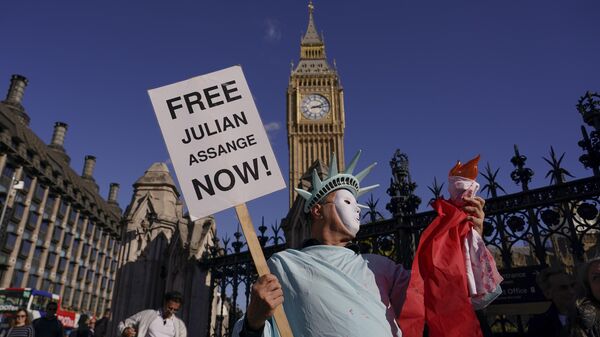 Pessoa segura cartaz em apoio ao denunciante Julian Assange, por sua possível extradição aos EUA, em Londres, Reino Unido, 8 de outubro de 2022 - Sputnik Brasil