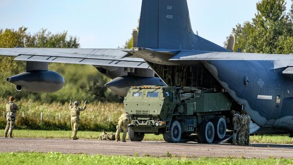 Soldados carregam um sistemas de lançadores múltiplos de foguetes norte-americanos (Himars) de uma aeronave MC-130J das Operações Especiais dos EUA durante exercícios militares no Aeroporto de Spilve em Riga, Letônia, 26 de setembro de 2022 - Sputnik Brasil