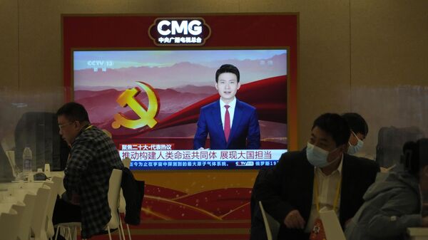 Jornalistas chineses junto de tela mostrando conteúdos do China Media Group em uma coletiva de imprensa realizada à margem do 20º Congresso do Partido em Pequim, 20 de outubro de 2022. - Sputnik Brasil