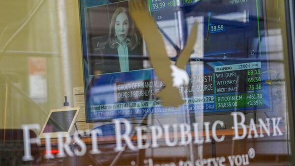 Uma tela de televisão exibindo notícias financeiras, incluindo o preço das ações do First Republic Bank, é vista dentro de uma das agências do banco no Distrito Financeiro de Manhattan, 16 de março de 2023 - Sputnik Brasil