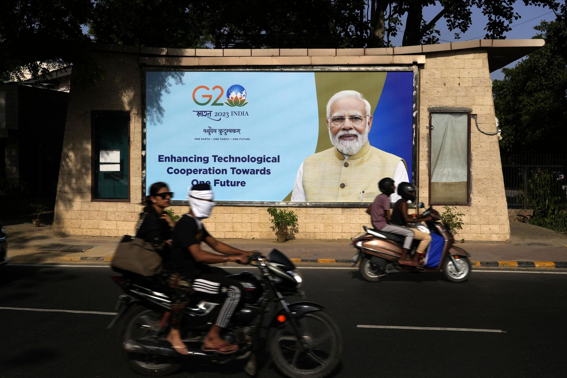 Motociclistas passam por um outdoor com o primeiro-ministro indiano Narendra Modi antes da cúpula do G20 em Nova Deli, Índia, 4 de setembro de 2023 - Sputnik Brasil, 1920, 07.09.2023