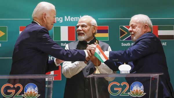 O presidente dos EUA, Joe Biden, à esquerda, o primeiro-ministro indiano Narendra Modi, ao centro, e o presidente brasileiro, Luiz Inácio Lula da Silva, de mãos dadas enquanto participam do lançamento da Aliança Global de Biocombustíveis na cúpula do G20 em Nova Delhi, Índia, sábado, 9 de setembro. , 2023 - Sputnik Brasil