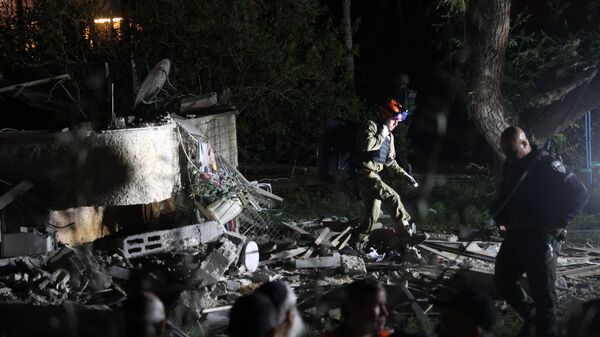 Membros das forças de segurança israelenses verificam casa que foi danificada por foguete disparado da Faixa de Gaza em Lod, nos arredores de Tel Aviv, Israel, 2 de novembro de 2023 - Sputnik Brasil